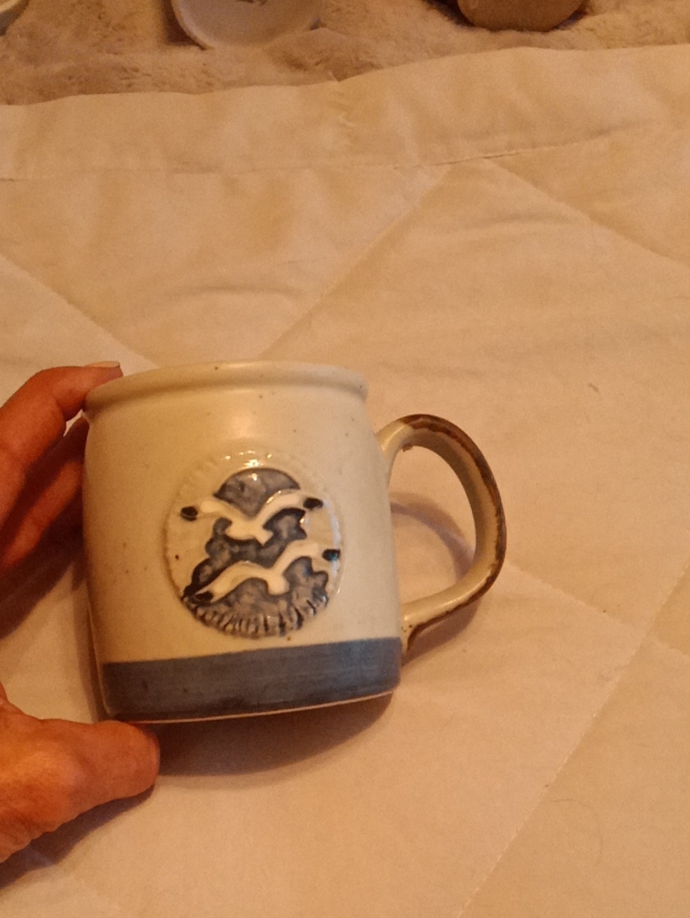 Handcrafted White Ceramic Mug with Blue Seagull Motif